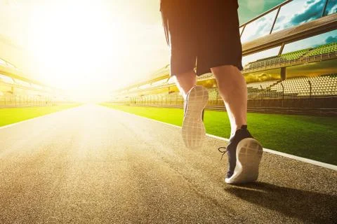 Close up of runner legs run on the stadium . Stock Photos