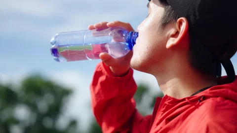 Close up of runner man drinking water after jogging. Video stock 248122453