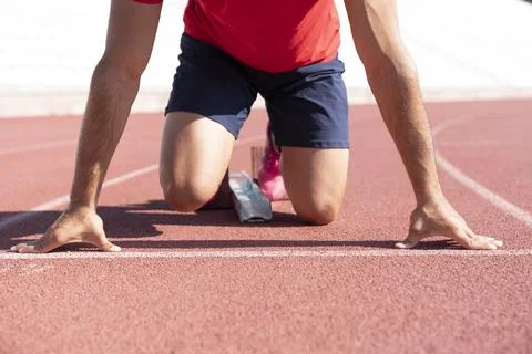 Close-up of runner ready to run on starting line Stock Photos