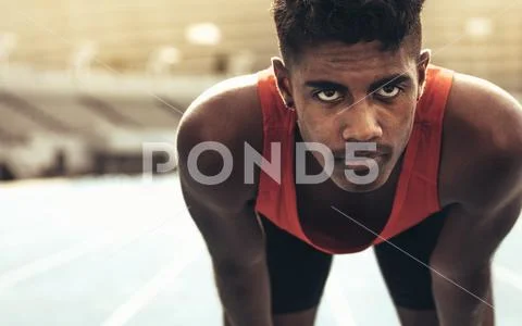 Close up of a runner standing on a running track Stock Photos