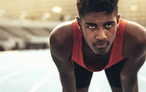 Close up of a runner standing on a running track Stock Photos