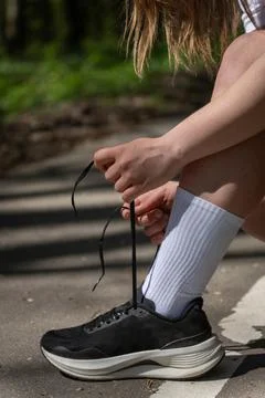 Close-up of a runner tying a black sneaker Stock Photos