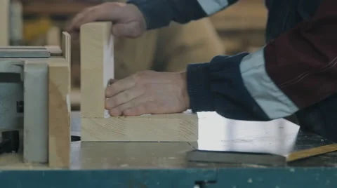 Close-up of running a board of lumber through a wood jointer power tool Stock Footage 61425609