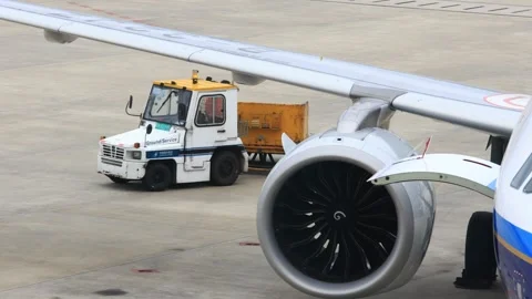 Close-up of a running flight engine and ground service car 動画素材 304221791