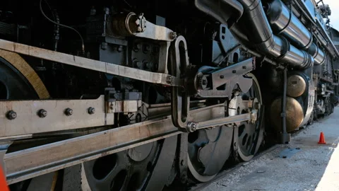Close up of the running gear and driving wheels on steam locomotive. Detailed Stock Footage 338318726