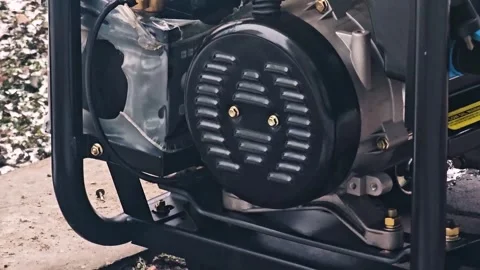 Close Up of Running Portable Gas Generator Engine with Protective Black Cover Stock Footage 339944654