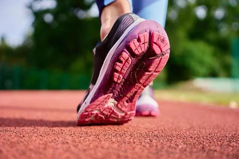 Close up of running shoe sole on stadium track Stock Photos
