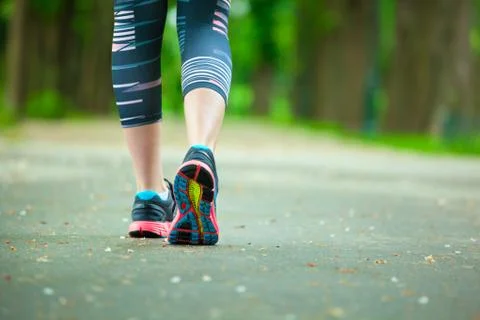 Close up of running shoes on road. Stock Photos
