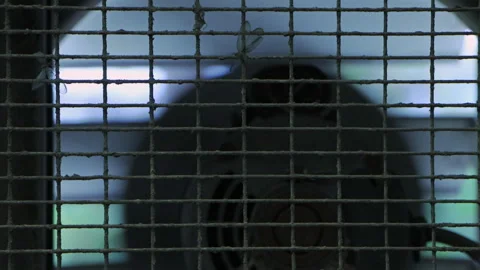 CLOSE UP OF A RUNNING VENTILATION FAN WITH DIRTY GRILL- TILT DOWN Stock Footage 315150581