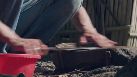 Close up of rural man sharpening knife with stone, Laos Stock Footage 134287534
