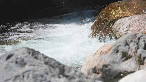 Close up of rushing river water splashing over rocks Stock Footage 329021530