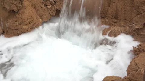 Close-Up of Rushing Water Pumping from Rusty Industrial Pipe into Dirt Basin Vídeos de archivo 334806377