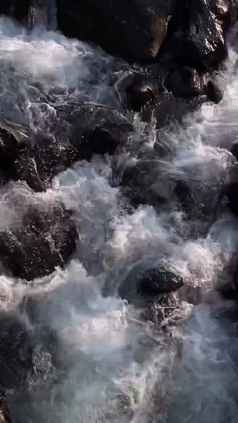 Close-Up of Rushing White Water Stream Flowing Over Dark Rocks Stock Footage 339765030