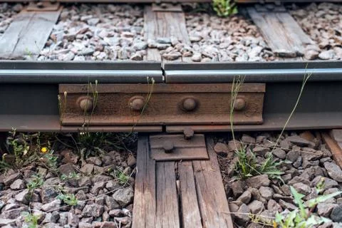 A close-up of rust metal rivets. Old sleepers, in city there is a tram line. In Stock Photos