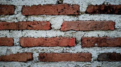 Close-up of a rustic brick wall with red bricks and white mortar, showcasin.. Stock Photos