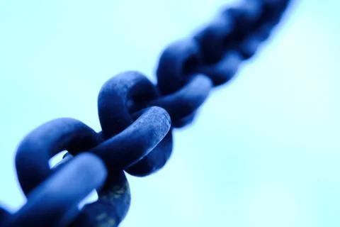 Close up of rustic chain in cold blue tone color Foto stock