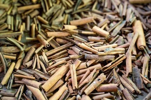 A close-up of rustic cinnamon sticks, arranged in an overlapping pattern. T.. Stock Photos