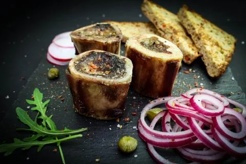 Close up of rustic english bone marrow, pickled onion and toast Stock Photos
