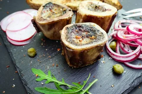 Close up of rustic english bone marrow, pickled onion and toast Stock Photos