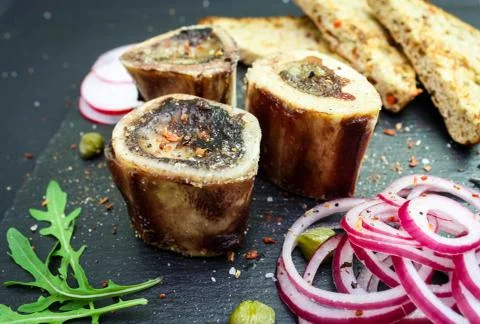 Close up of rustic english bone marrow, pickled onion and toast Stock Photos