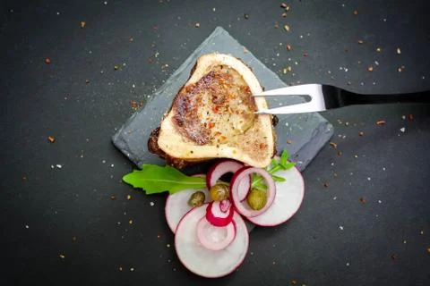 Close-up of rustic English bone marrow with pickled onions, radishes and cape Stock Photos