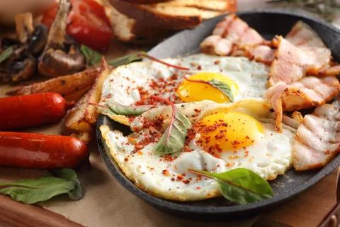 Close up of rustic full english breakfast on a white wooden table Stock Photos