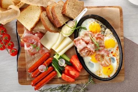 Close up of rustic full english breakfast on a white wooden table Stock Photos