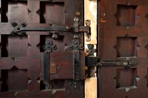 A close-up of a rustic lock and hinges on a church door in the UK Stock Photos