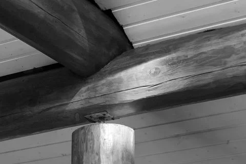 Close-up of a rustic log beam ceiling and round support post Stock Photos