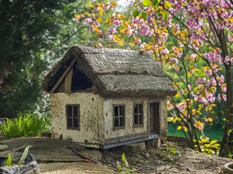 Close-up of a rustic miniature house with a thatched roof Stock Photos