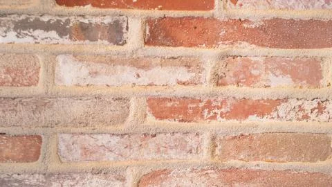 Close-up of rustic red brick wall with weathered texture Stock Photos