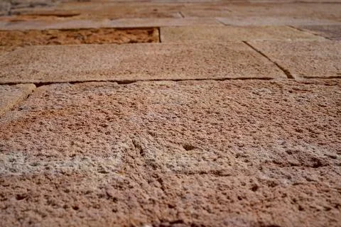 Close up of rustic reddish stone tile pavement detail in Barcelona Spain wi.. Stock Photos