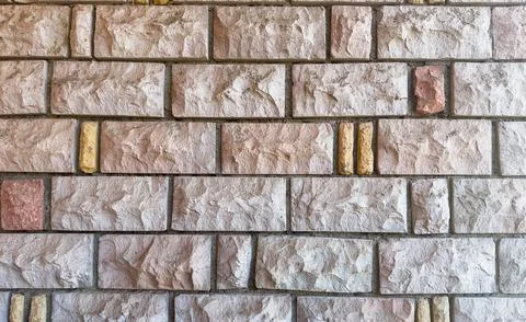 Close-up of rustic stone wall with irregular granite rocks Stock Photos