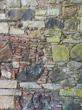 Close-up of rustic stone wall with irregular granite rocks Stock Photos