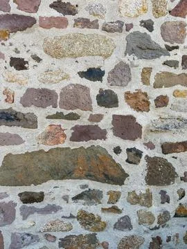 Close-up of rustic stone wall with irregular granite rocks Stock Photos