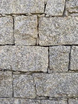 Close-up of rustic stone wall with irregular granite rocks Stock Photos