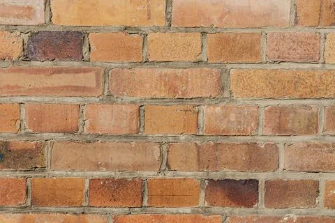 Close-up of rustic weathered brick wall with warm tones Fotos de archivo