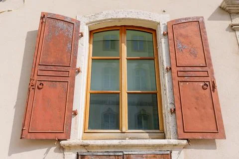 Close Up of Rustic Window with Metal Shutters in Switzerland 写真素材