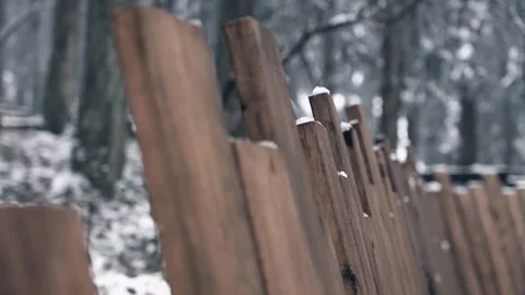Close up of a rustic wooden fence with light snow in winter forest Stock Footage 341948831