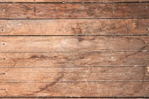 Close-up of a rustic wooden surface with visible grains, knots, and nail marks. Stock Photos
