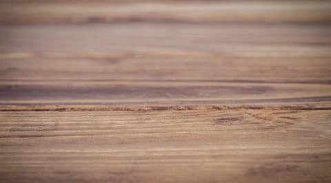 Close-up of a rustic wooden table with a blurred natural background Stock Photos