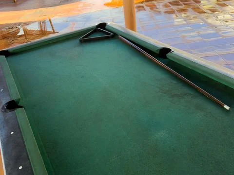 Close up of a rustic wooden triangle pool rack and worn billiard cue stick .. Stock Photos