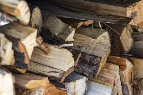 A close-up of a rustic woodpile, featuring various sizes and textures of ch.. Stock Photos