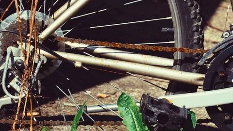Close up of a rusty bicycle chain being cut with sparks flying Stock Photos