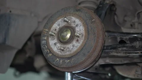 Close-up of a rusty car rear brake drum with studs. Stock Footage 345708170