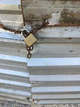 Close up of a rusty chain and gate lock Stock Photos