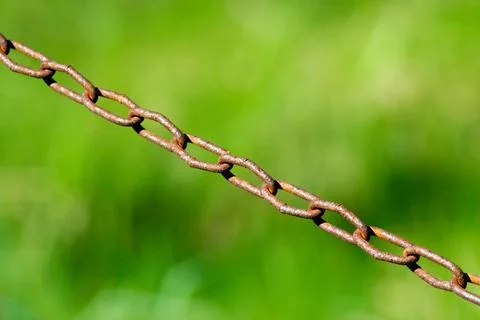 Close up rusty chain on grass background Stock Photos