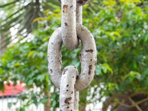 Close up of rusty chain links in the foreground Foto stock