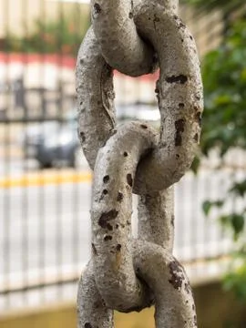 Close up of rusty chain links in the foreground Stock Photos