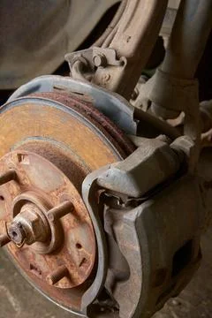 Close-up of rusty disk brake, steering knuckle and suspension Stock Photos